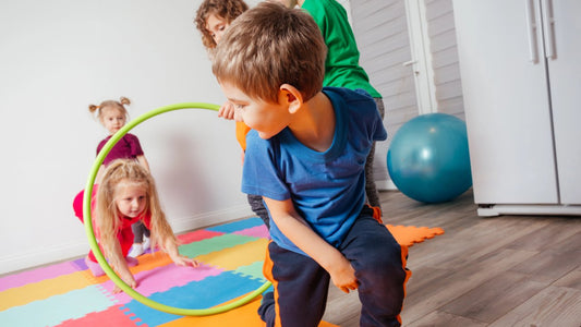 Toddler crawling through a tunnel in obstacle course for kids